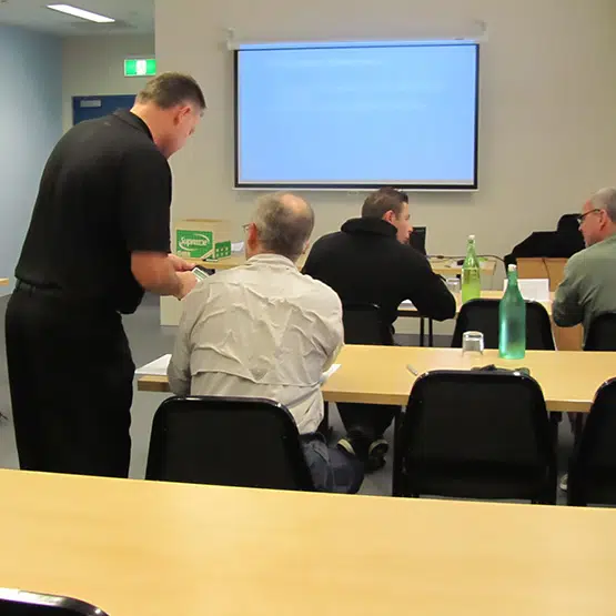 Professional swimming pool maintenance team at Crane Aquatics during a training session.