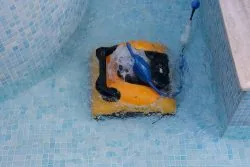 Robotic pool cleaner Dolphin W20 in action in a swimming pool.