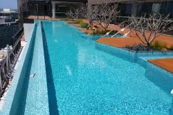 Rooftop pool at Skye Apartments with city views, featuring clear water and stylish surroundings.