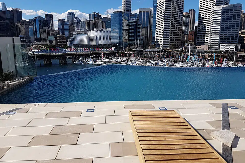 Modern pool at Sofitel with city skyline view in Sydney.