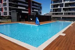 Rooftop swimming pool at Crown Street Wollongong with city views, perfect for relaxation and leisure.