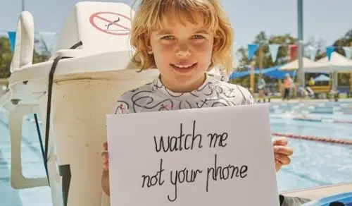 Child holding sign saying 